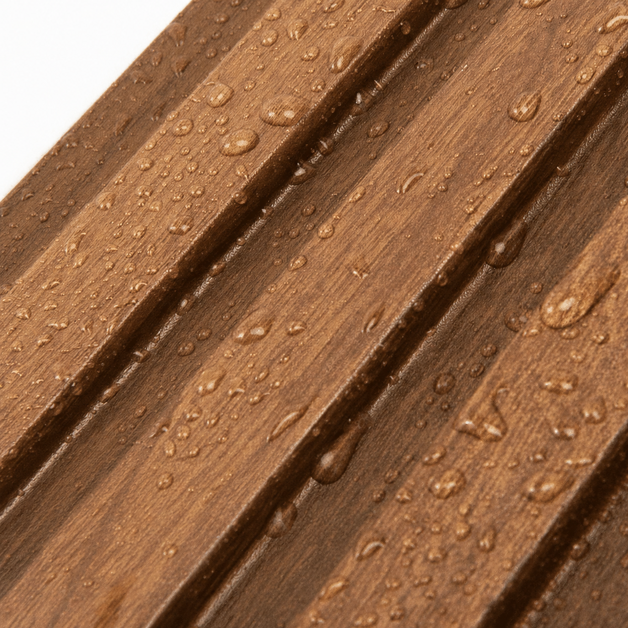 Close-up of brown wood-look WPC decking boards with water droplets, showing the moisture-resistant surface texture.